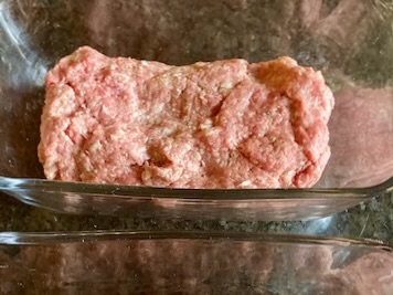 Eggless meatloaf in a glass baking dish before baking.