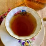NORA tea in a floral teacup.