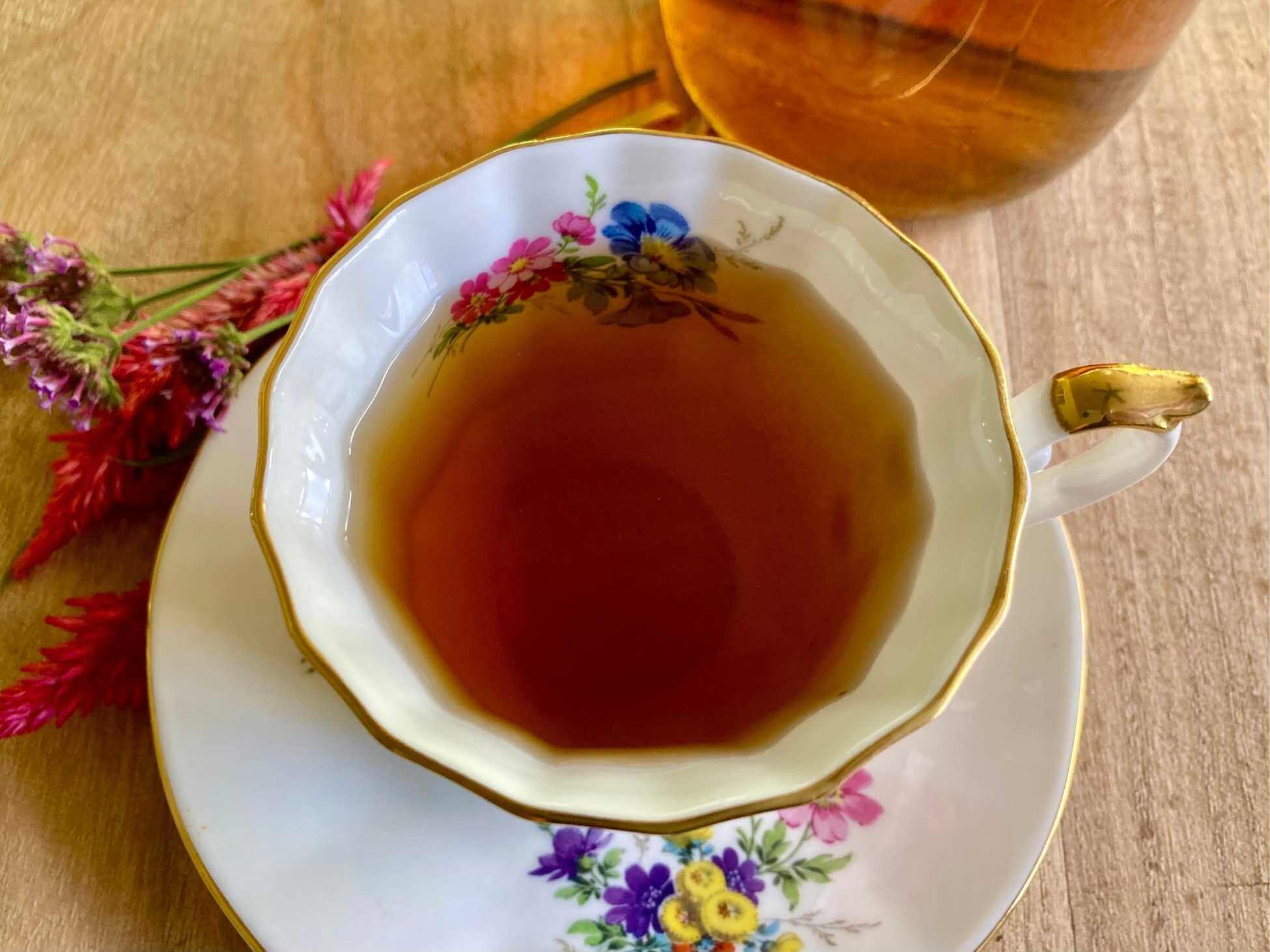 NORA tea in a floral teacup.