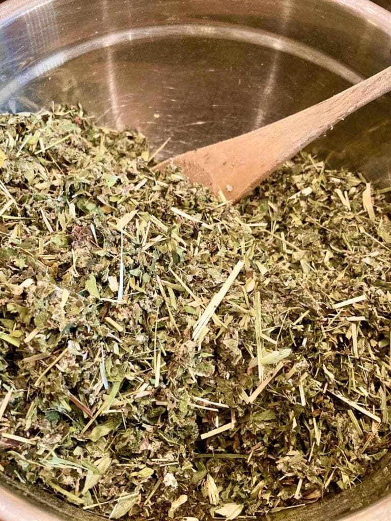 Stirring herbs in a bowl.