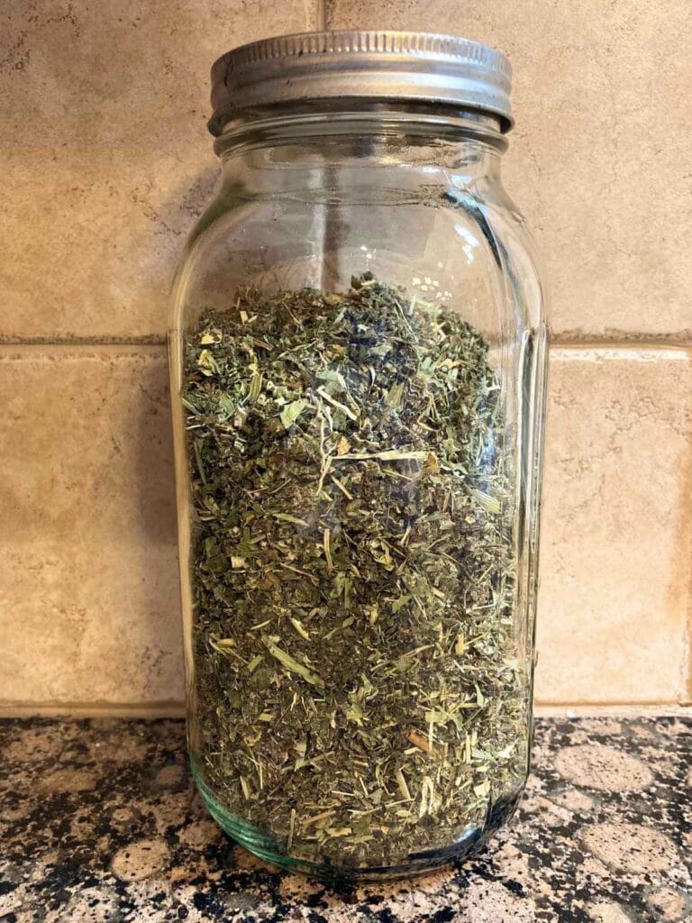 Dried herbal tea blend in a mason jar.