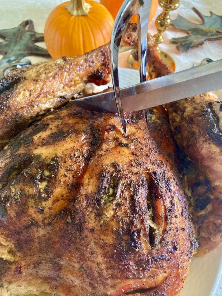 Thanksgiving turkey with a knife about to carve it.