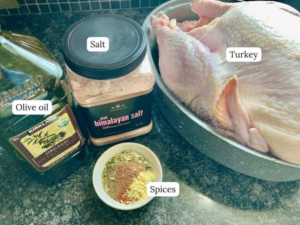 Ingredients for making a Thanksgiving turkey on a black counter.