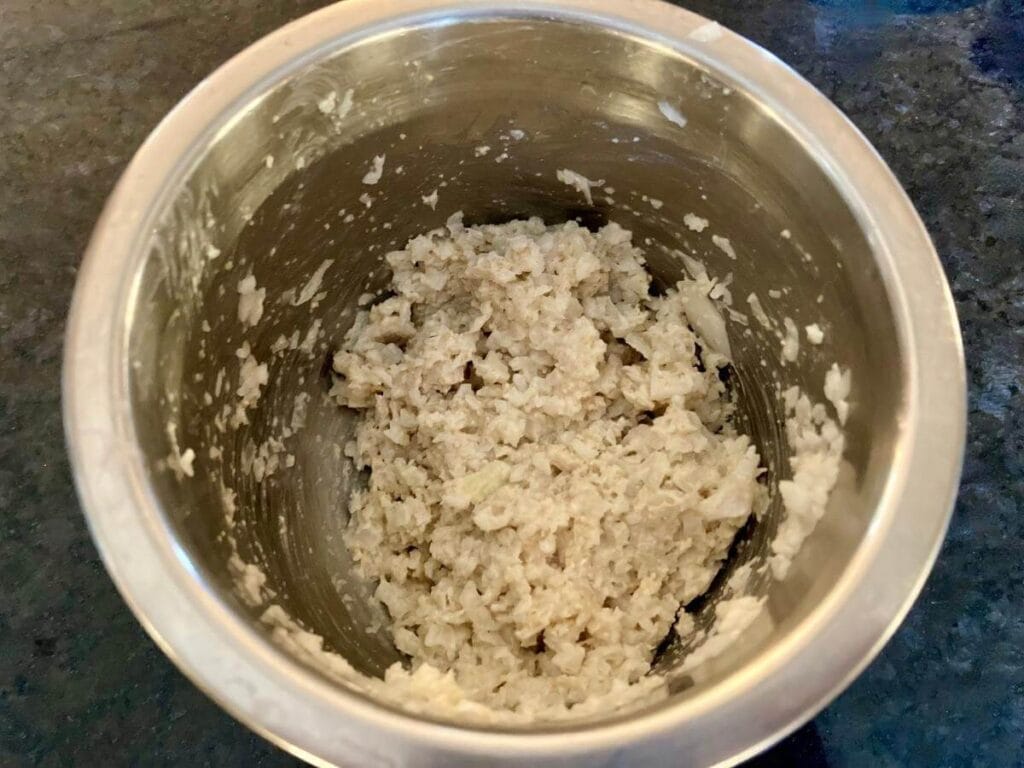 Oat flour and pureed onion in a small bowl.