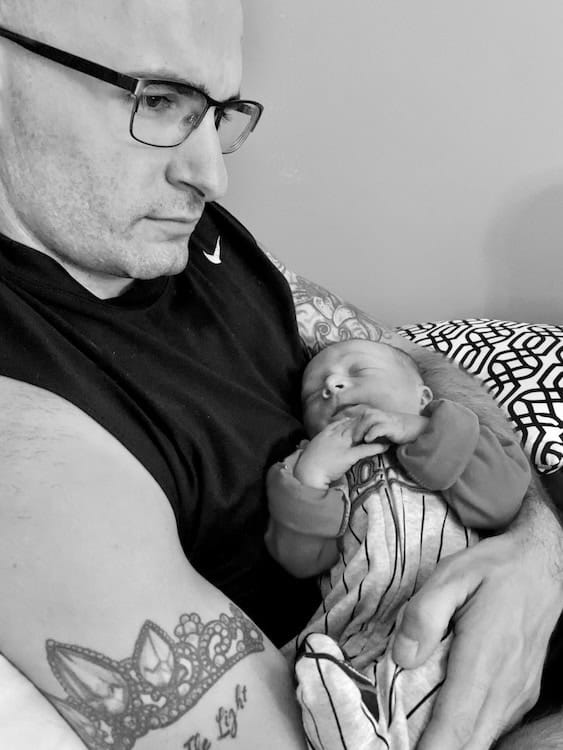 Father holding sleeping baby