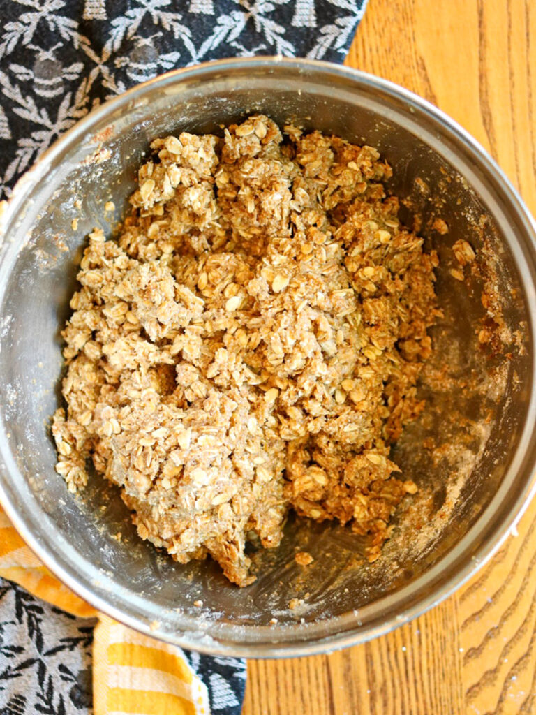 Ingredients for streusel topping mixed in a bowl on a table.