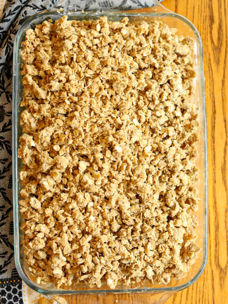 Streusel topping over an unbaked fruit crisp.