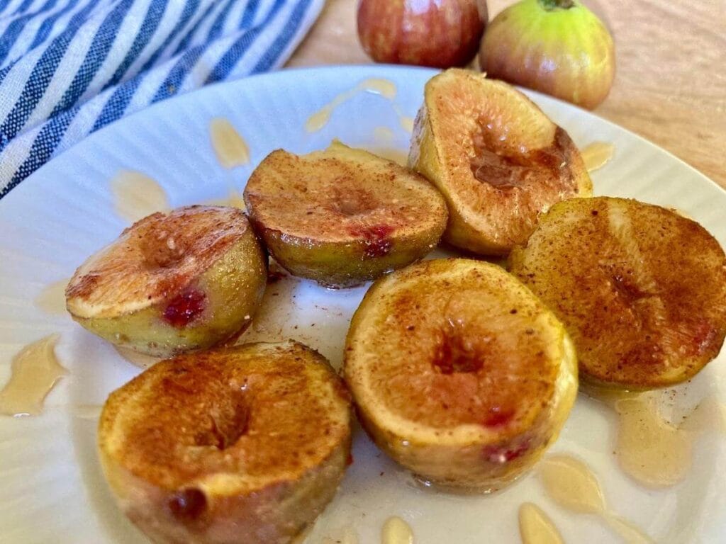 Closeup of roasted figs on a plate.