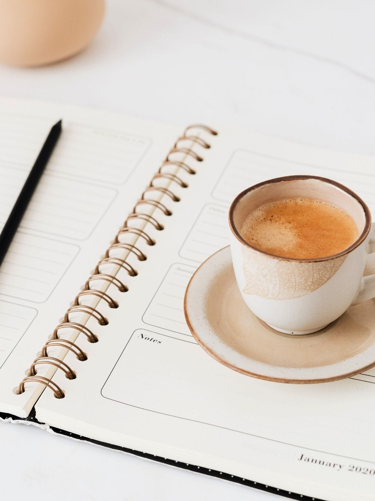 Cup of coffee on a daily planner.
