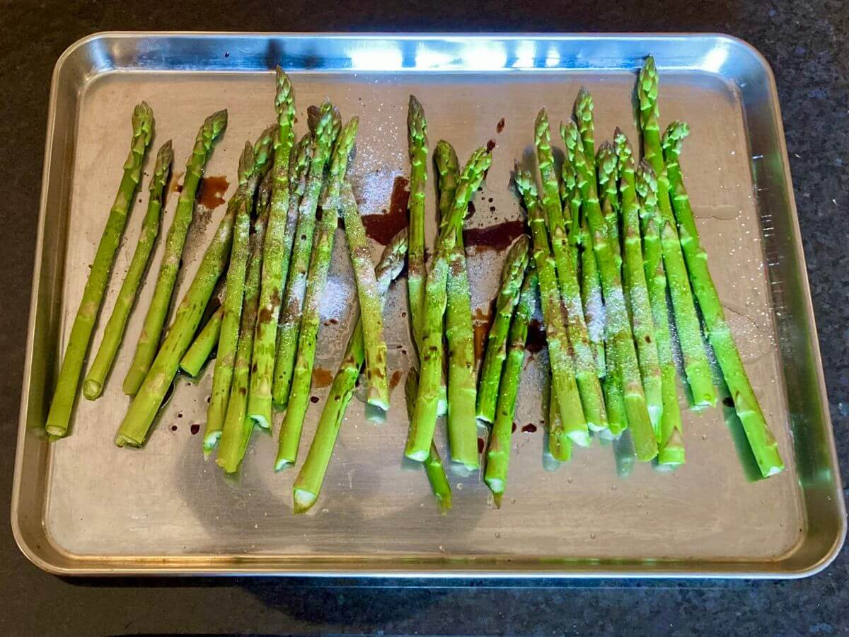 Asparagus with balsamic drizzled it over on baking sheet