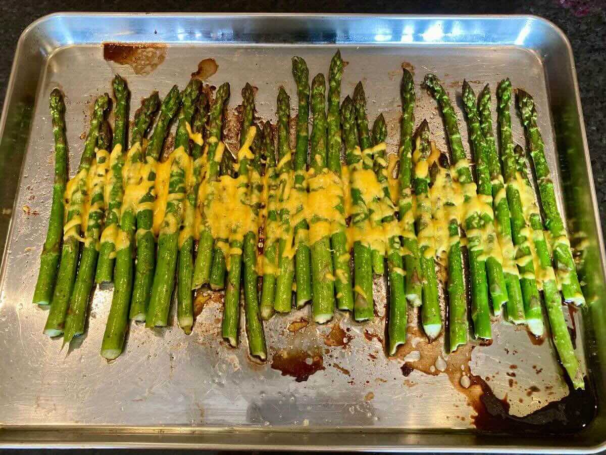 Asparagus with melted cheese on top