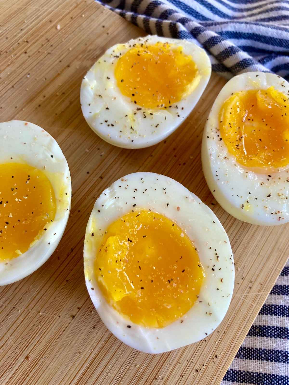 Medium boiled egg halves with salt and pepper