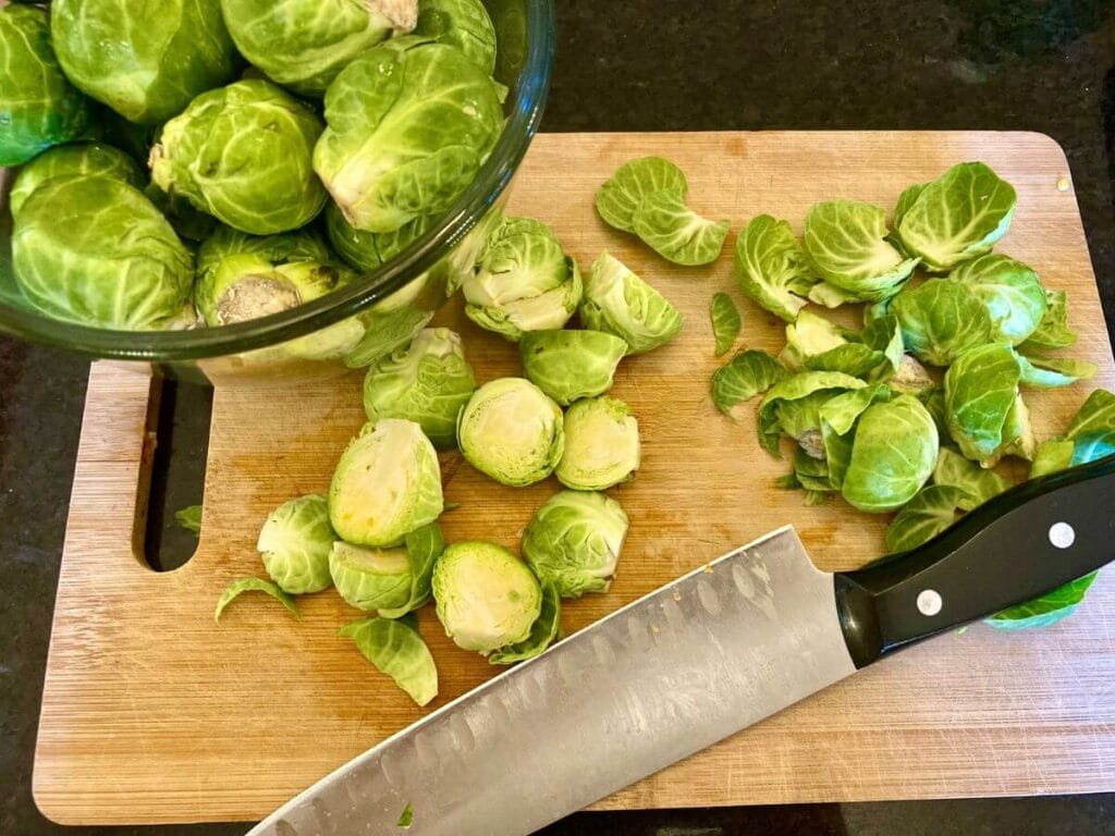 Roasted Brussels Sprouts and Butternut Squash Cutting Brussels sprouts in half