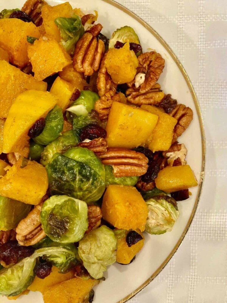 Serving bowl full of roasted Brussels sprouts and butternut squash