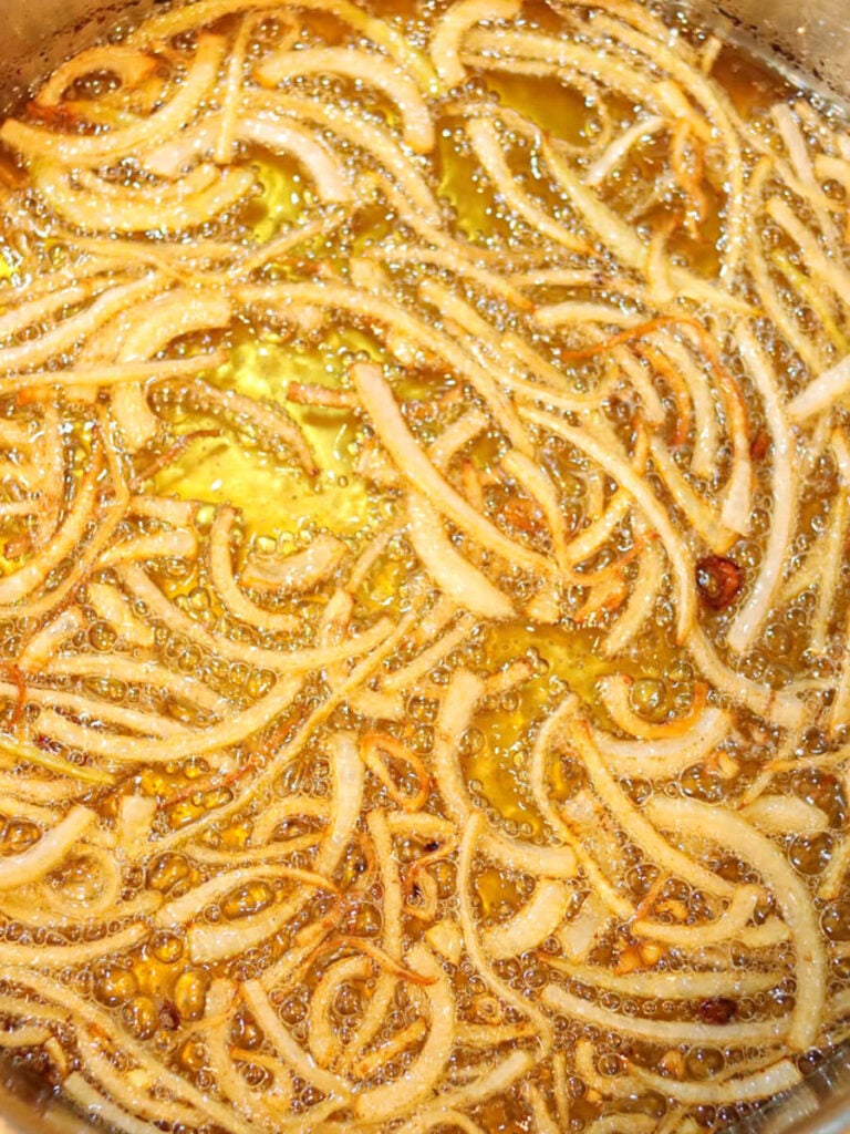 Close-up of onion slices just finished frying and ready to take out of the pan.