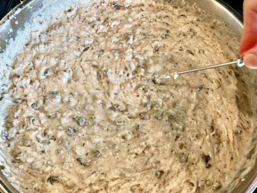 Whisking gluten-free cream of mushroom soup in skillet