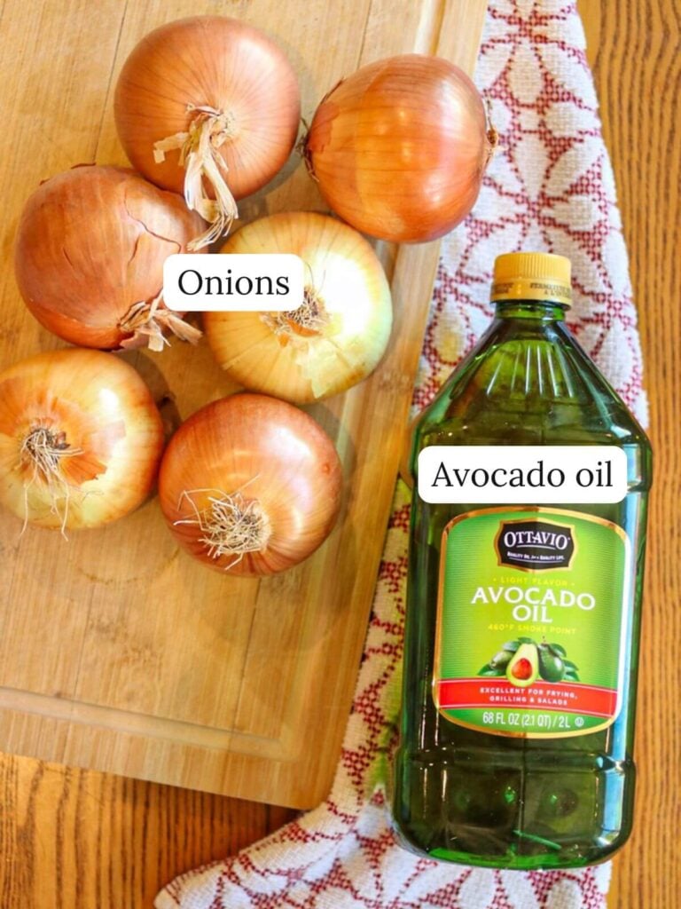 Labeled ingredients on a wooden table including fresh onions and a bottle of avocado oil.