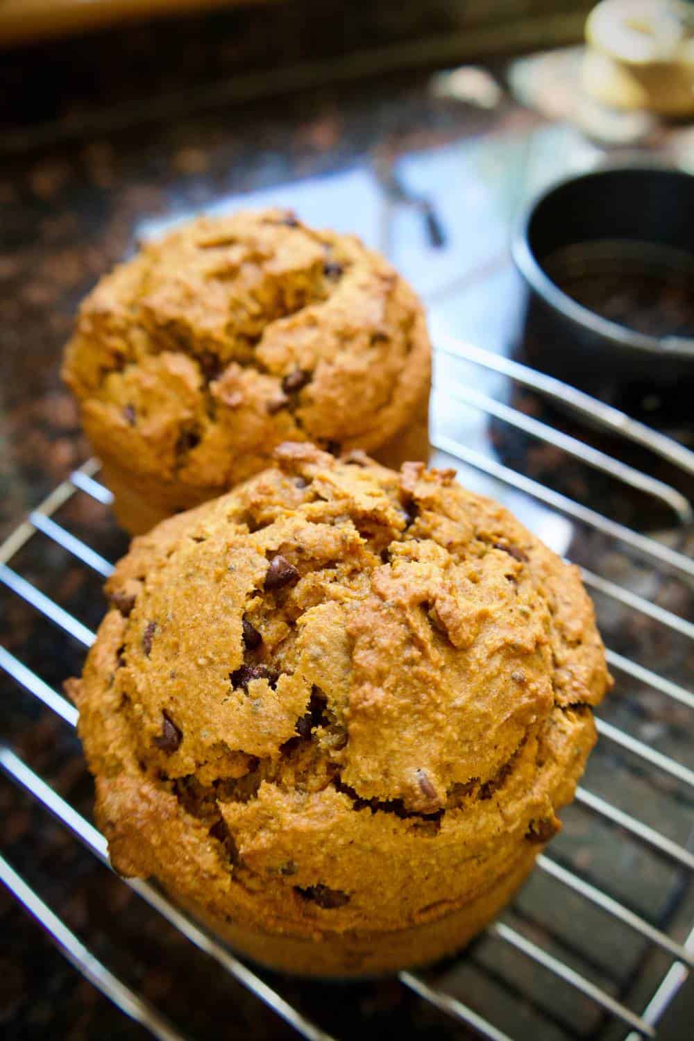 2 banana pumpin muffins on a cooling rack
