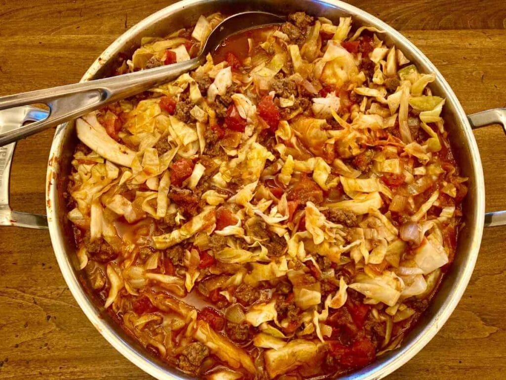 Skillet with cabbage roll in a bowl