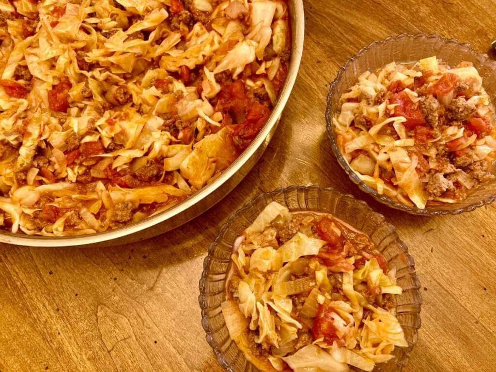 Skillet and two bowls of cabbage roll in a bowl