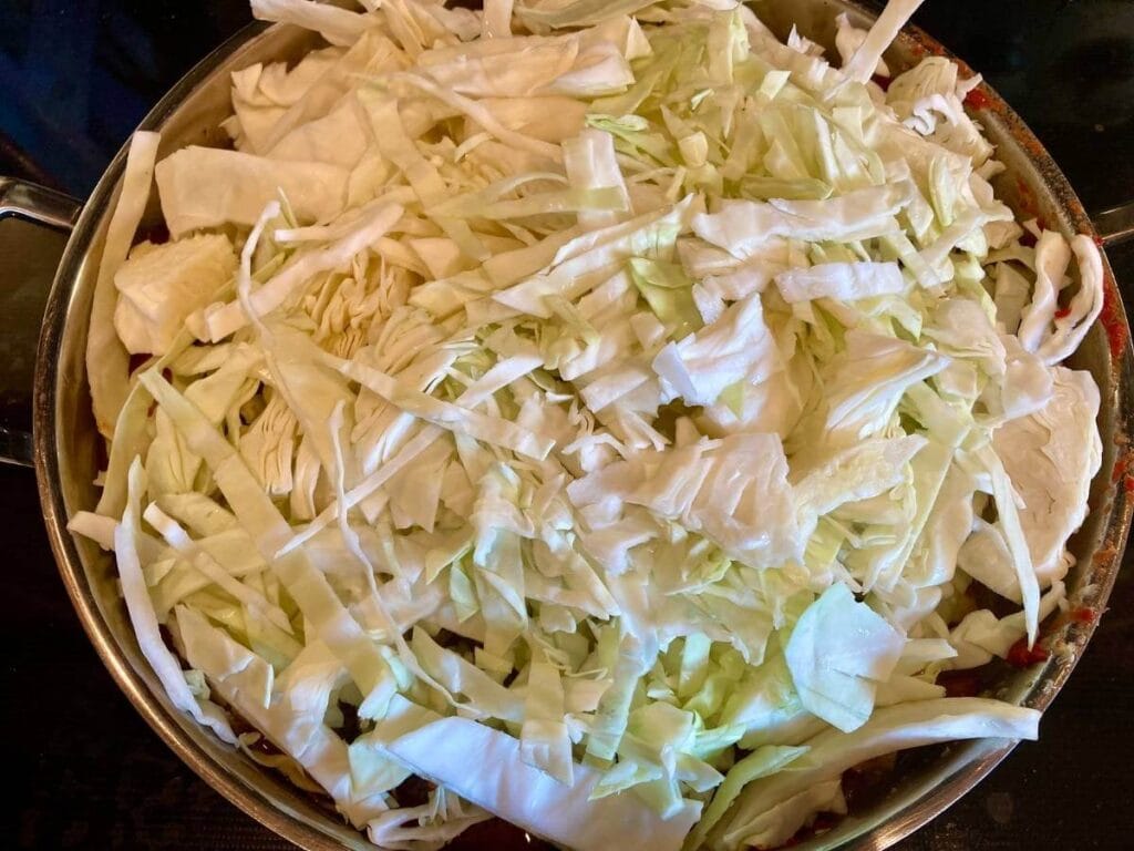Sliced cabbage in skillet