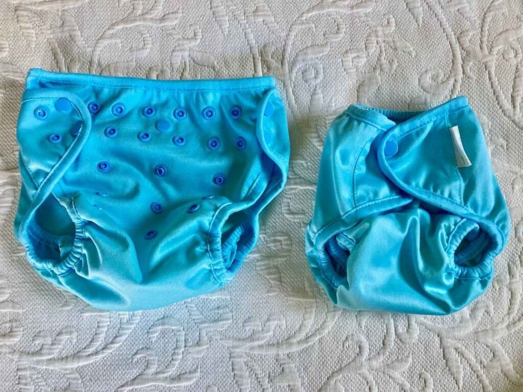 Two cloth diaper covers adjusted to different sizes