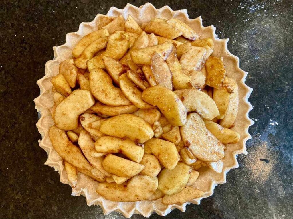 Apples in unbaked oat flour pie crust