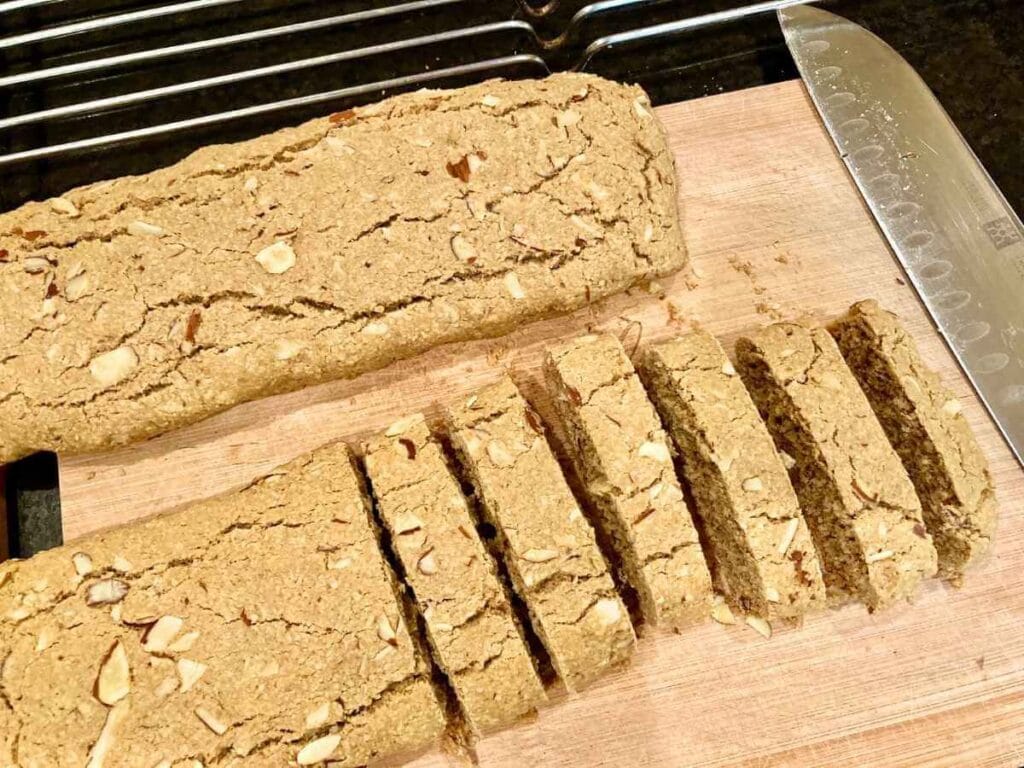 Slicing biscotti on cutting board