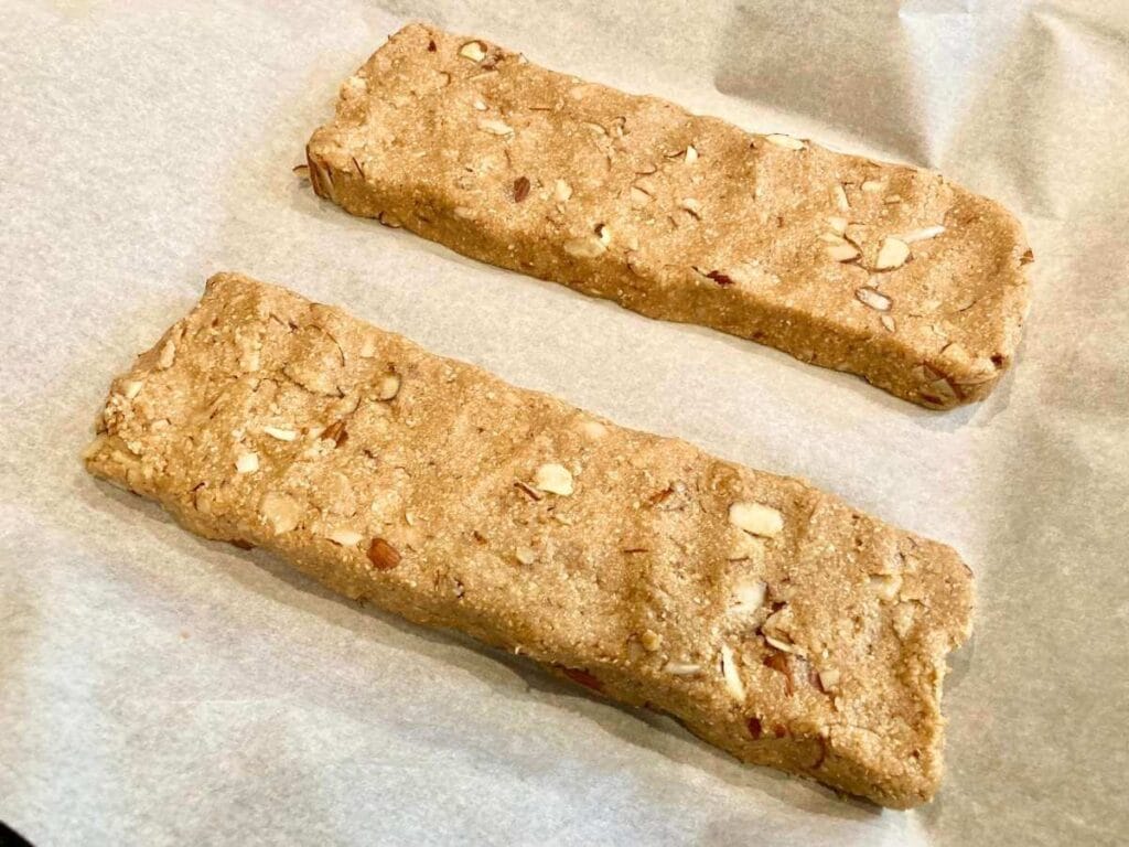 unbaked logs of dough on parchment paper