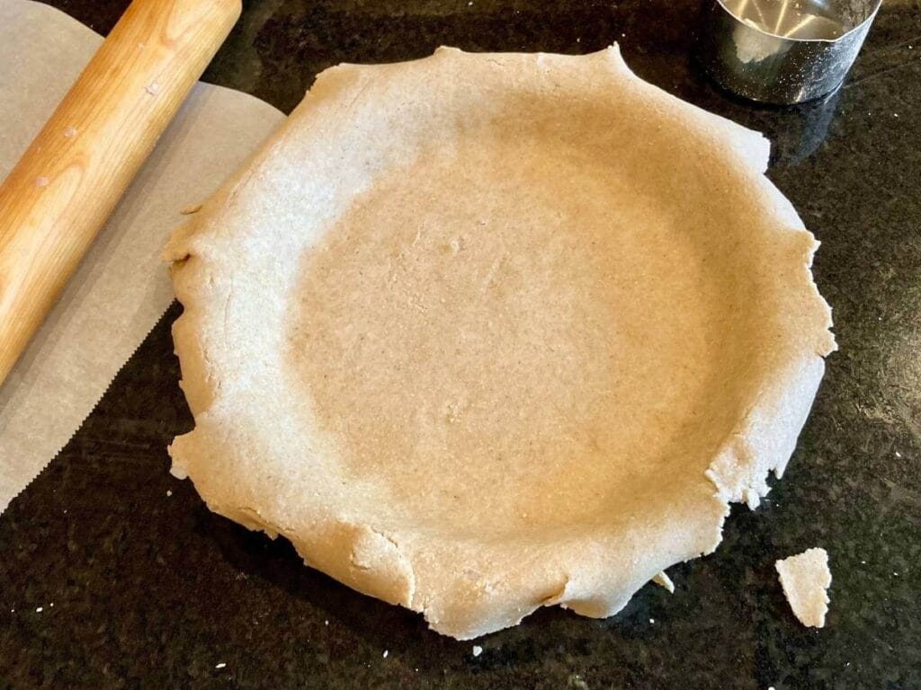 Unbaked oat flour pie crust in pie pan