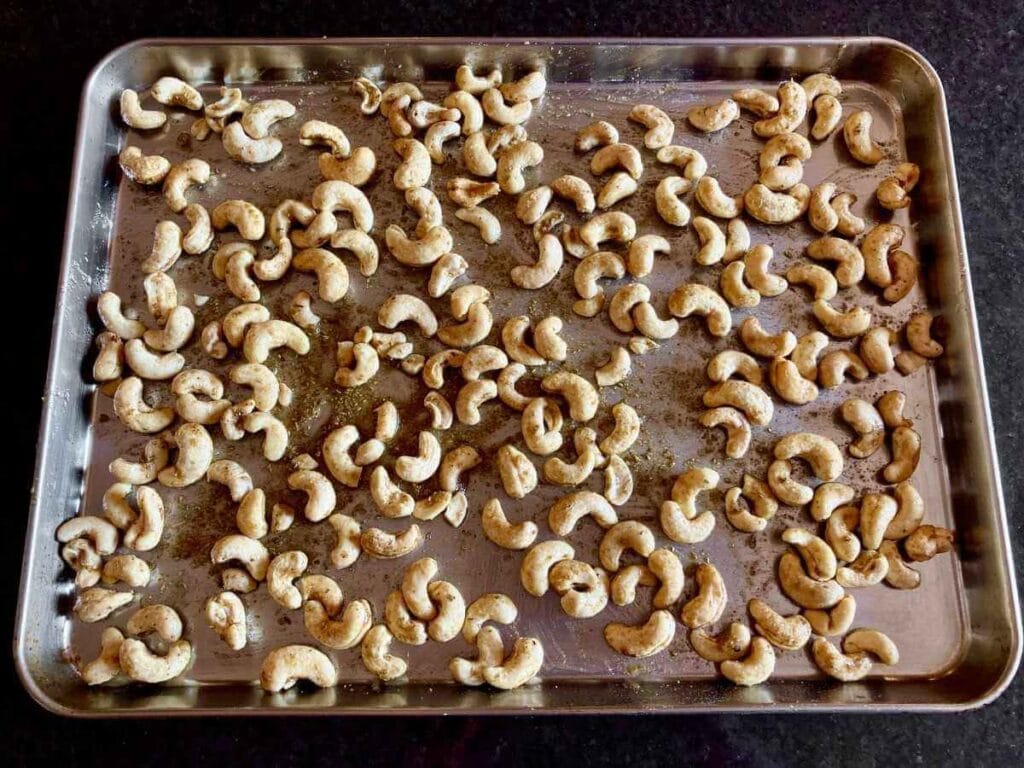 Cashews and spices on baking sheet