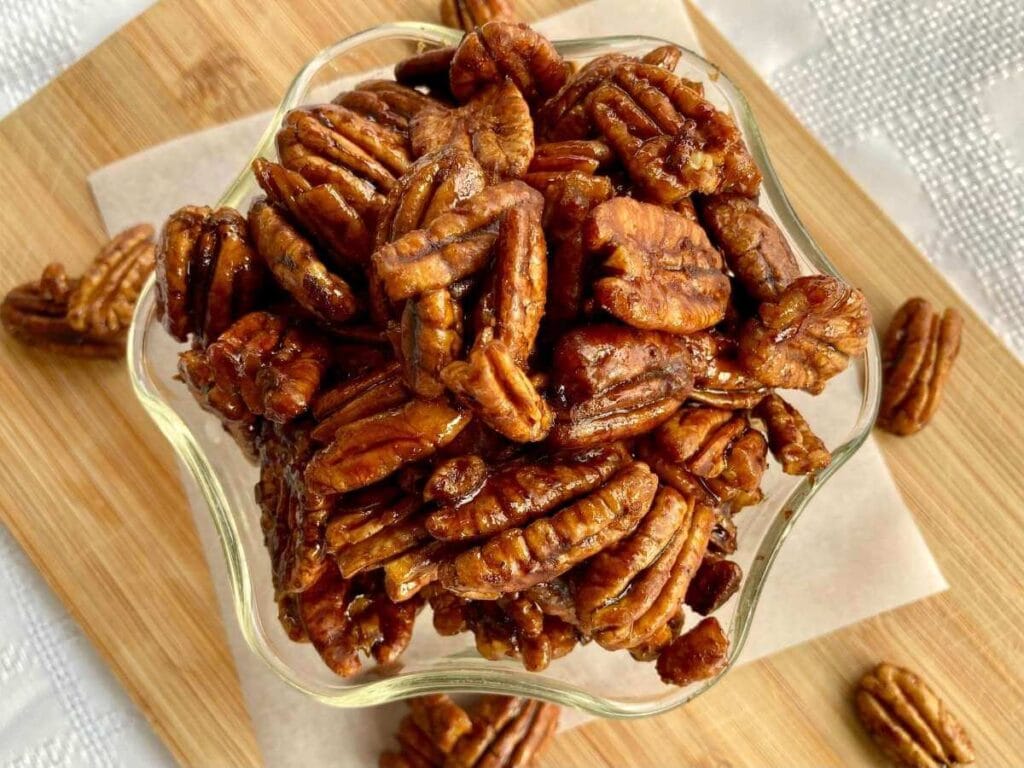 Candied pecans without eggs in a glass dish