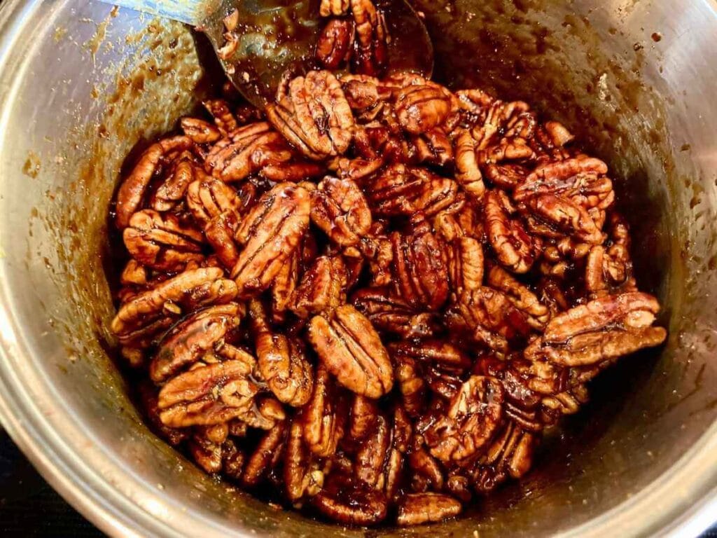 Candied pecans cooking in saucepan