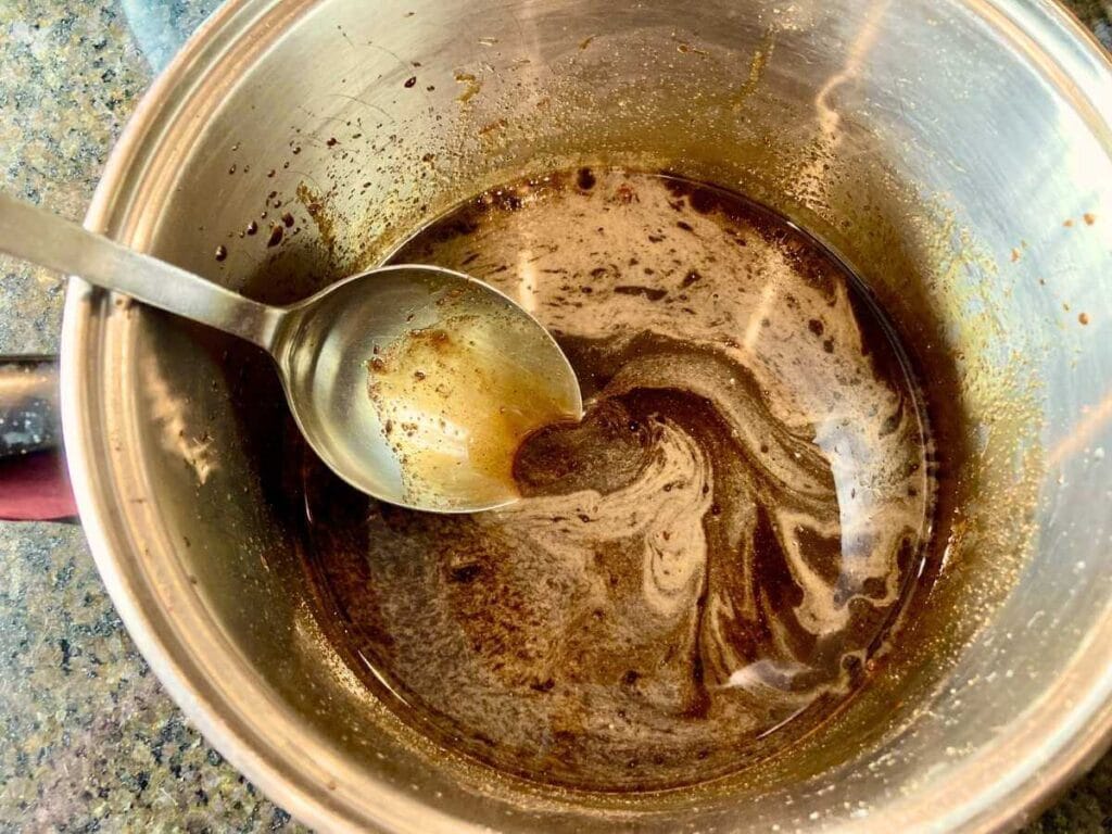Stirring sugar mixture in saucepan