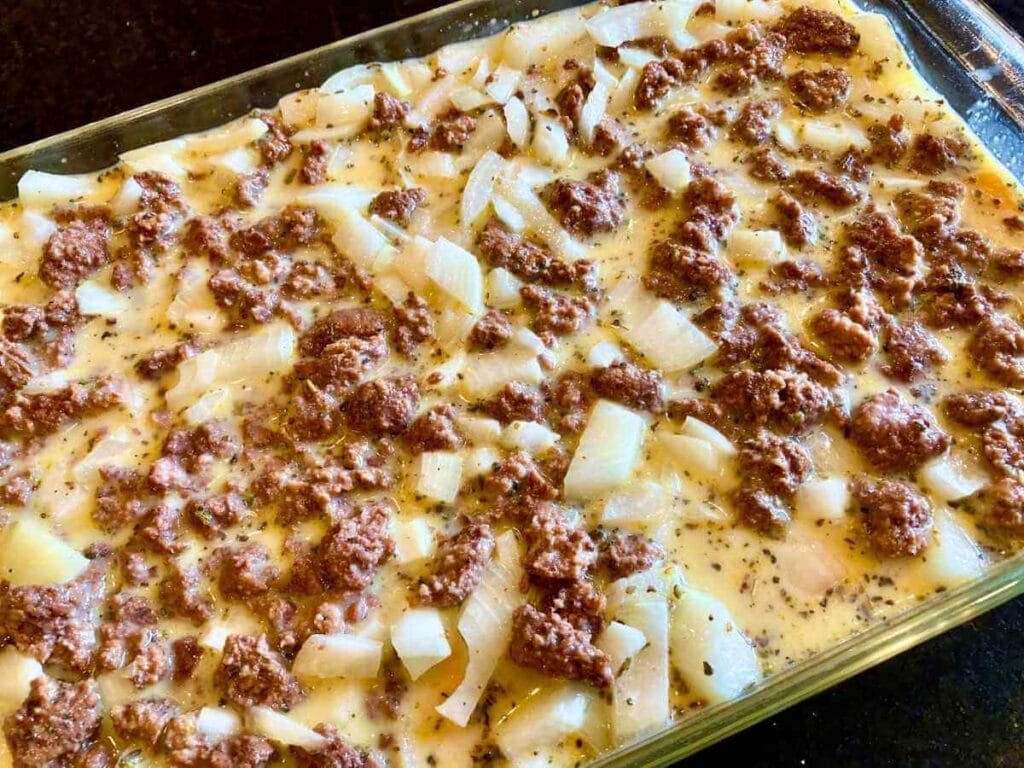 Unbaked healthy egg strata in a baking dish