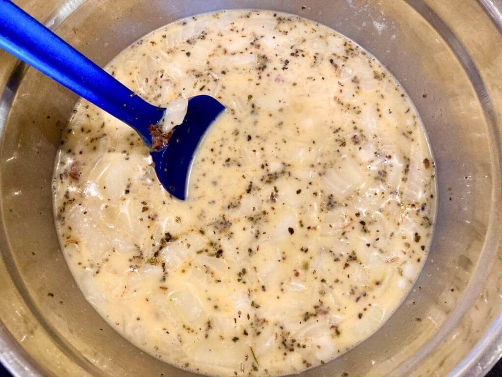 Stirring beef into egg mixture