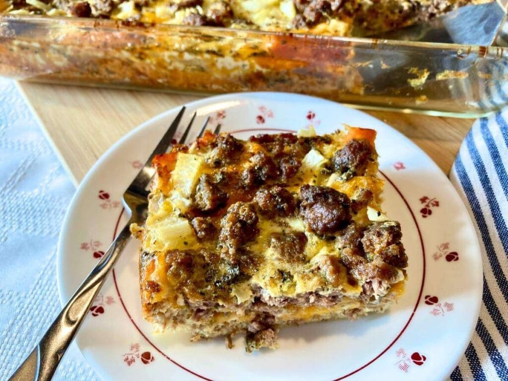 Slice of healthy egg strata on a plate with a fork