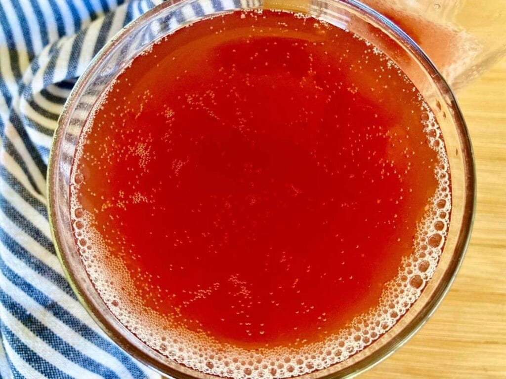 Top view of water kefir fizzing in glass