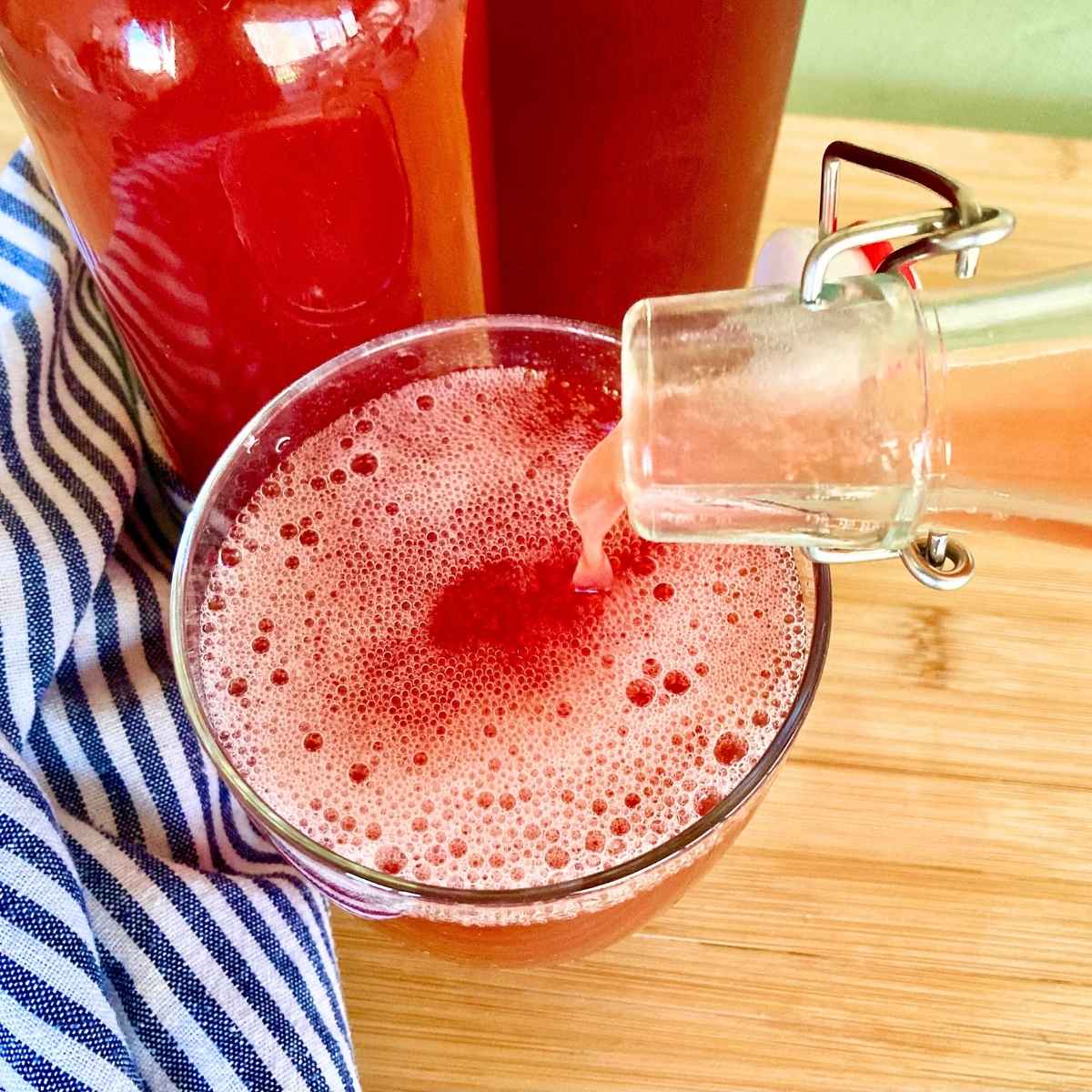 Closeup of pouring water kefir into glass