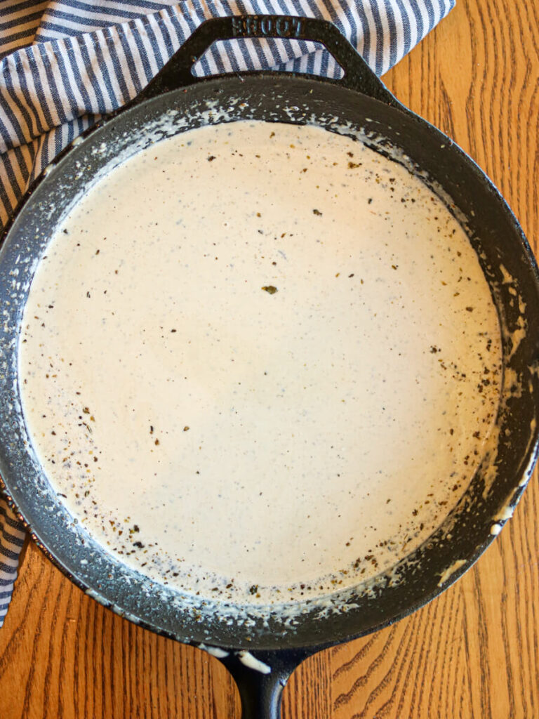 Sauce ingredients simmering in a cast iron skillet.