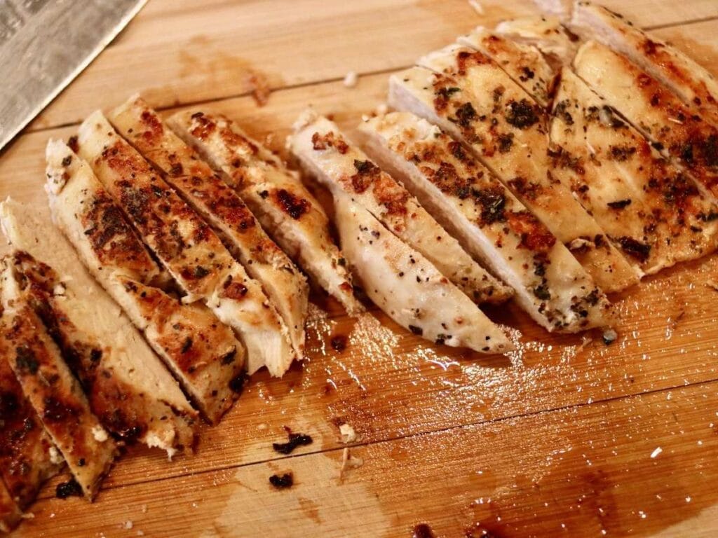 Sliced chicken breasts on a cutting board