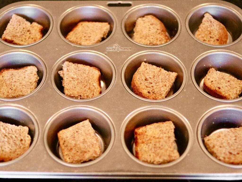 Adding bread quarters to muffin cups
