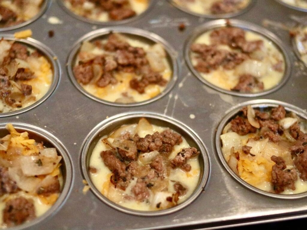Adding egg mixture to muffin cups