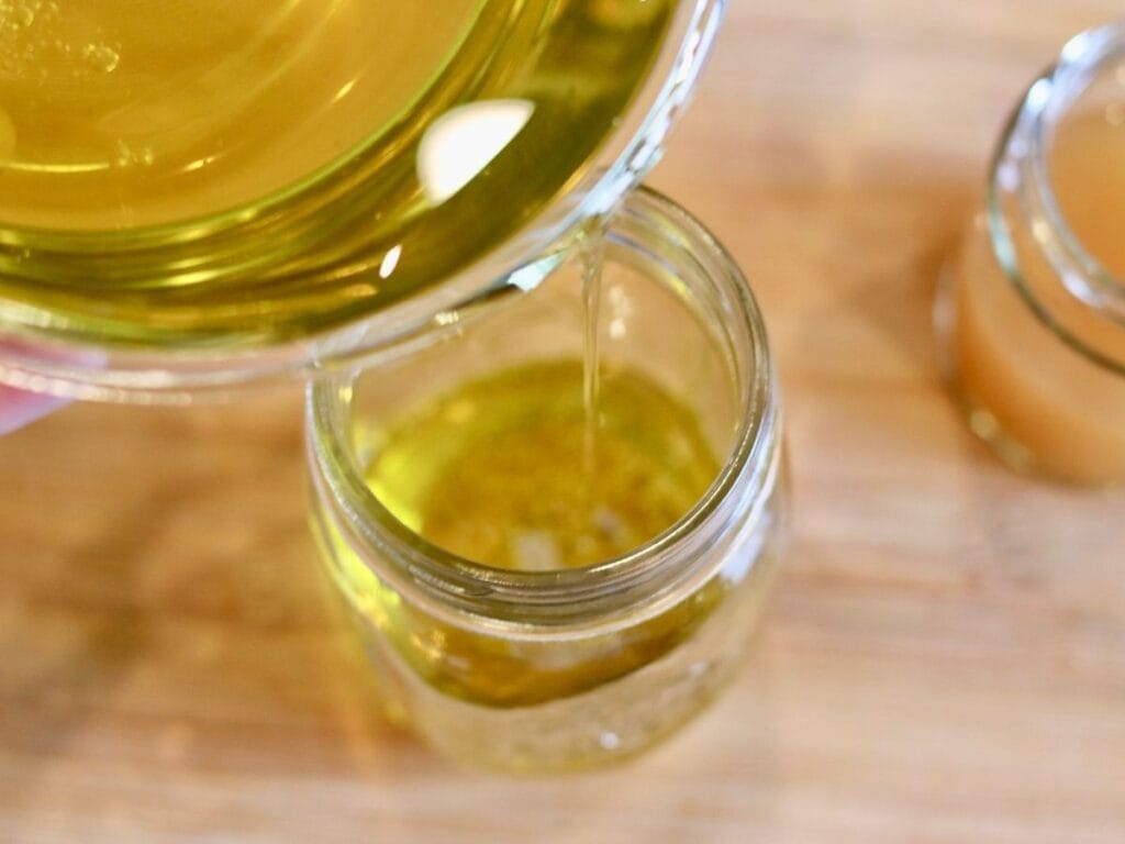 Pouring olive oil into a mason jar