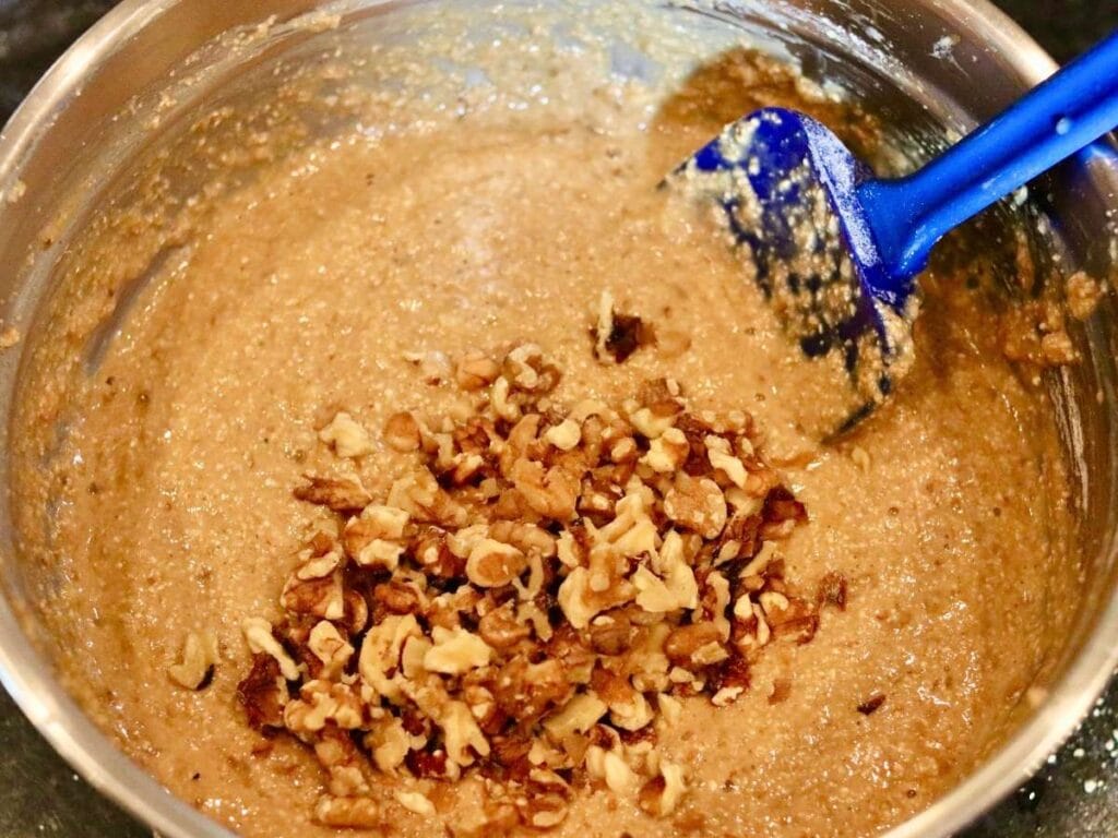 Folding walnuts into batter.
