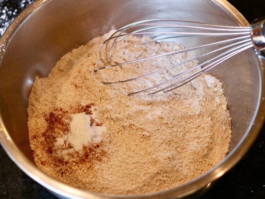 Whisking dry ingredients together.