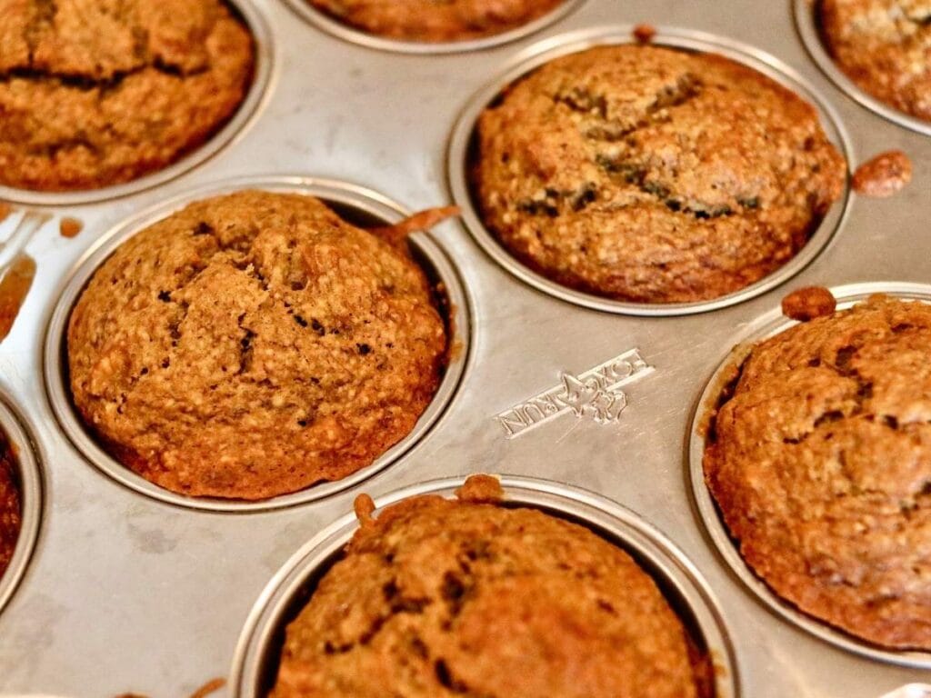 Oat flour banana muffins in a muffin pan right out of the oven.