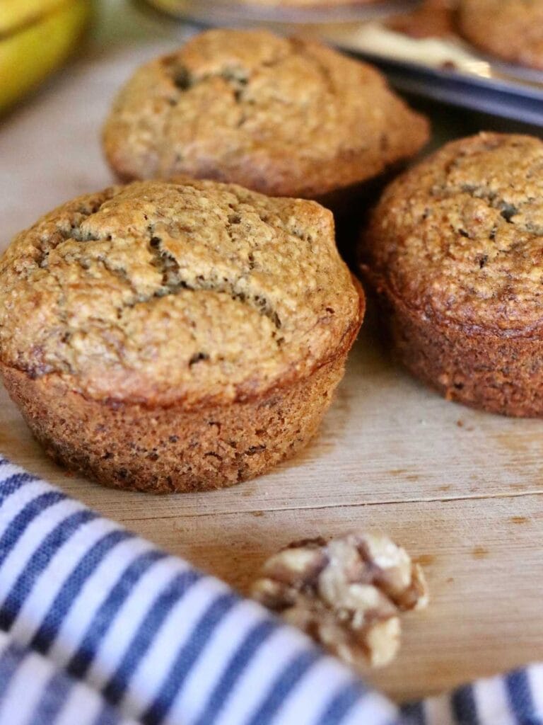 3 oat flour banana muffins with a cloth napkin.