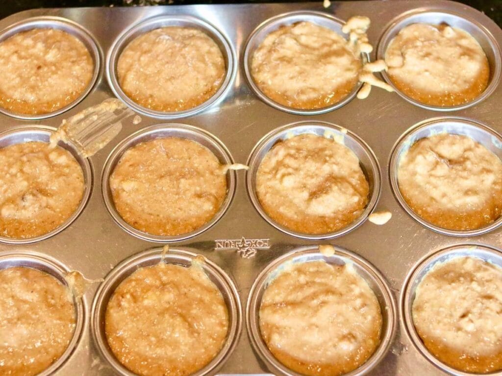 Oat flour banana muffins in a muffin pan before baking.