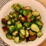 Stovetop Brussels sprouts in a bowl with a cloth napkin